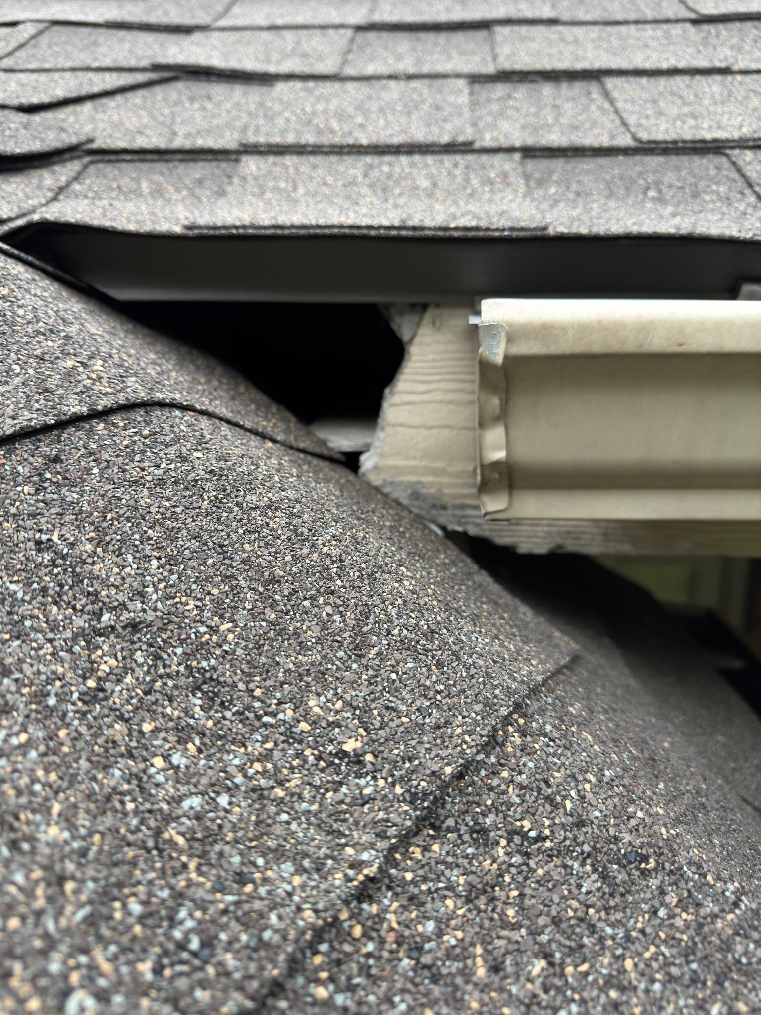 Open gap at the junction of a shingle roof and gutter