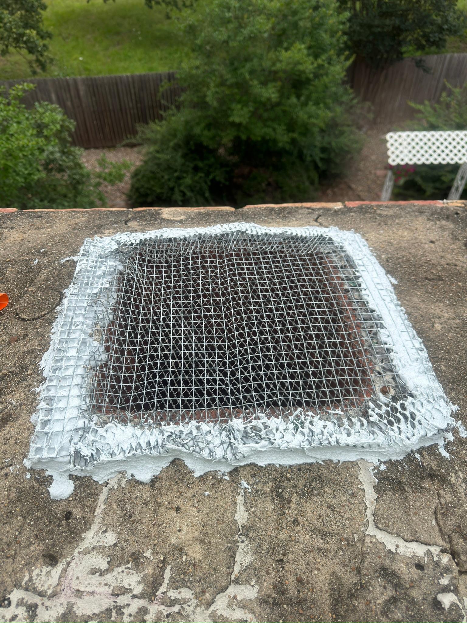 Square wire mesh cover sealed around the edge of a rooftop opening