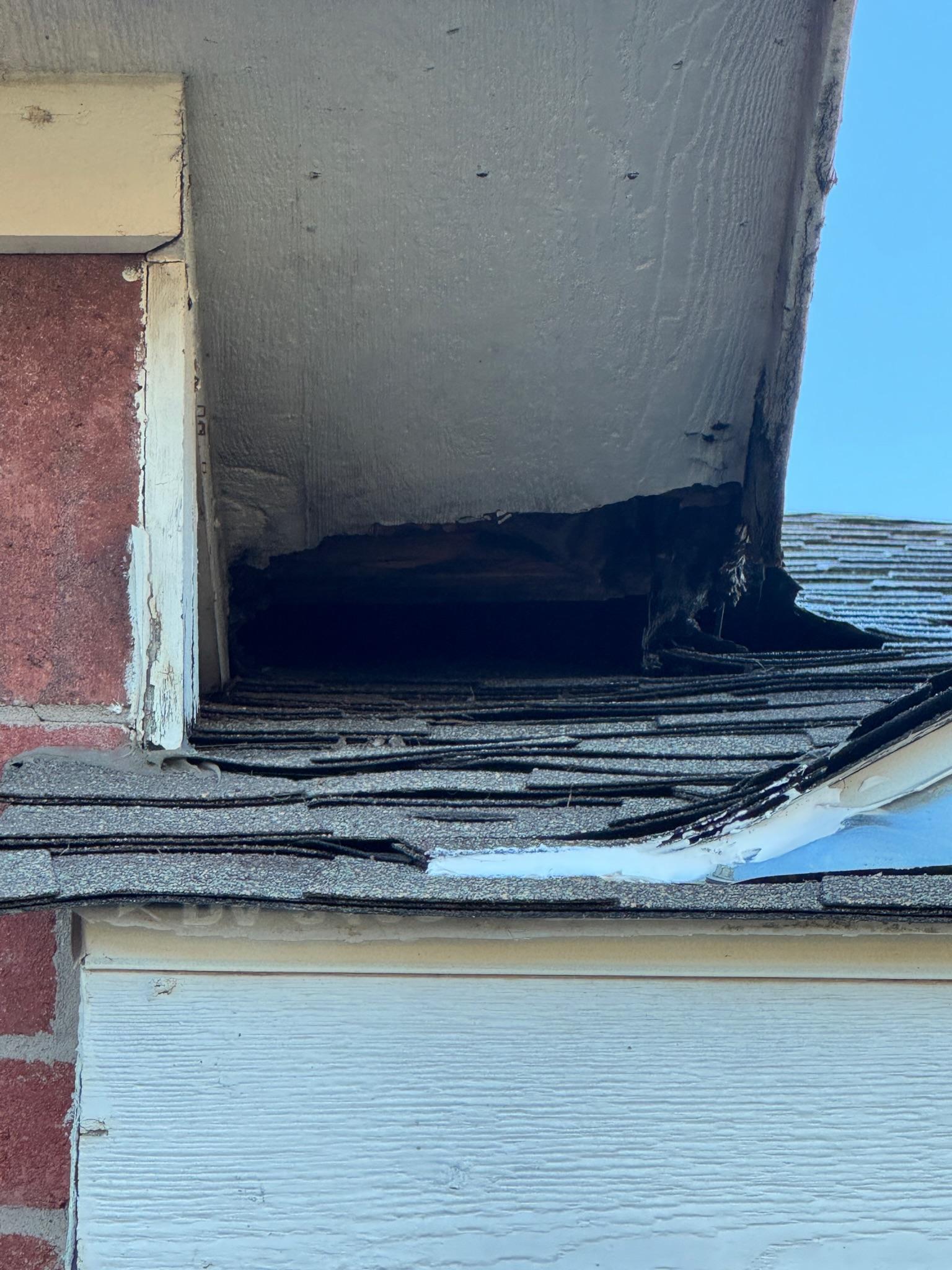 Dark flashing along the base of a chimney where it meets the roof