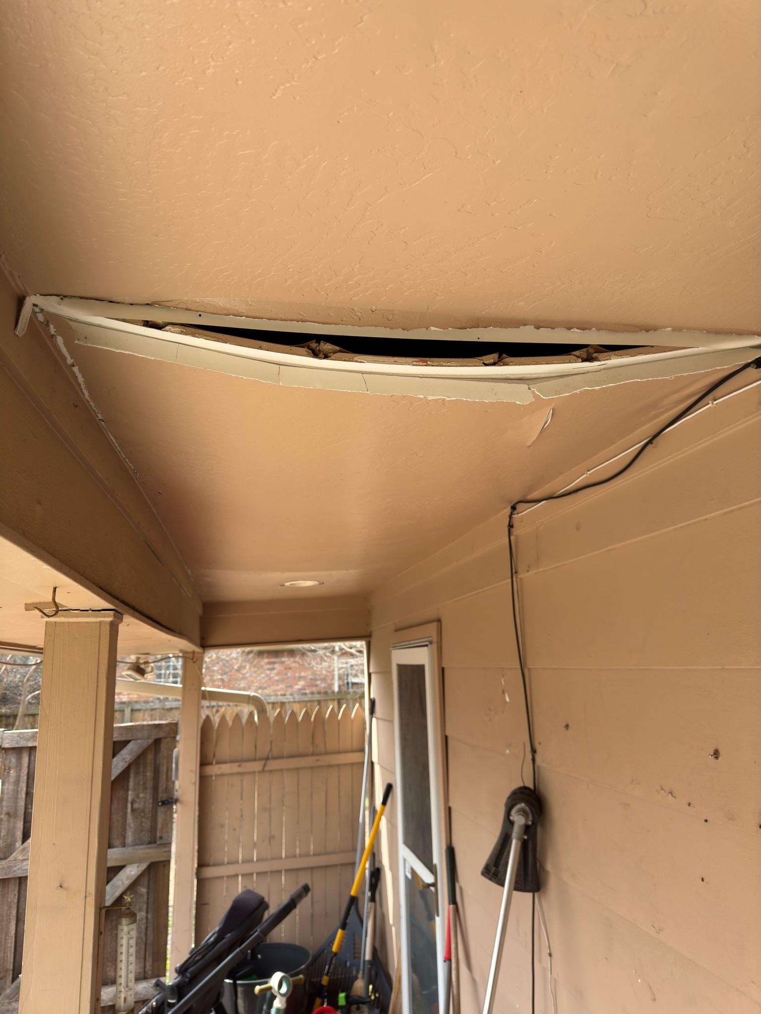 Sagging soffit panel leaving a long opening above a porch