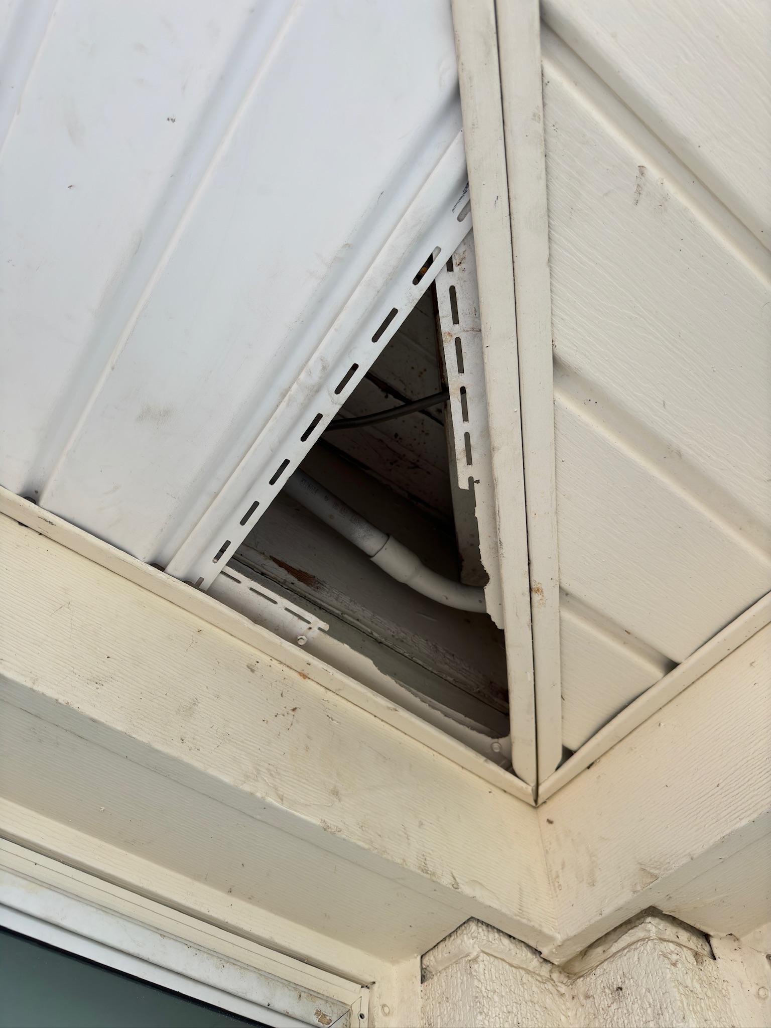 Triangular opening where soffit panels meet exterior siding
